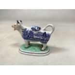 An Antique Staffordshire cow creamer in Willow pattern design. Damage to 1 horn W:16cm x H:12cm