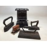 Four flat irons together with a cast iron paraffin flat iron heater W:18cm x H:25cm