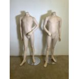 A pair of young boy mannequins with adjustable arms on circular metal bases. H:140cm