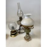 An oil lamp together with 2 electric lamps