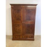 An Edwardian style inlaid double wardrobe with three drawers to base, mirror to reverse of door with