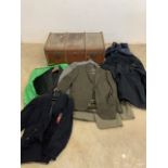 A vintage wood bound suitcase and contents-suits and coats.