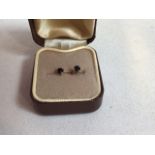 A pair of gold mounted sapphire stud earrings - hall mark to shank. Sapphire approx 3mm