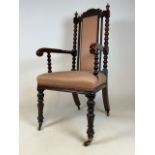 A Victorian bobbin turned armchair. With brass castors. Seat height H:44cm