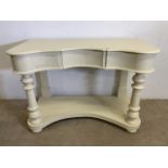 A painted pine wash stand with curved front and central drawer. W:108cm x D:53cm x H:74cm
