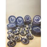 A large quantity of blue and white china comprising mainly willow pattern. Tea cups and saucers, tea