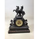 A decorative spelter clock with rearing horses on marble plinth. W:35cm x D:15cm x H:44cm