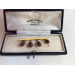 A 15 carat gold bar brooch set with seeds W:4cm