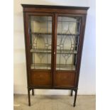 An Edwardian inlaid glazed cabinet with hidden cupboard and lined back and shelves. (A.F glass