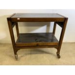 A mid century Beswsay metamorphic tea trolley into tea table on large castors. W:77cm x D:38cm x H: