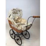 A wicker childs pram with real fur cats W:25cm x D:61cm x H:66cm