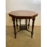A 20th century octagonal inlaid table on.castors with galleried under shelf. W:75cm x D:75cm x H: