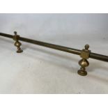 A brass curtain rail. W:152cm