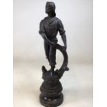 A shelter figure of a fisherman on a wooden base (un fixed) label to base Le Matin H:52cm