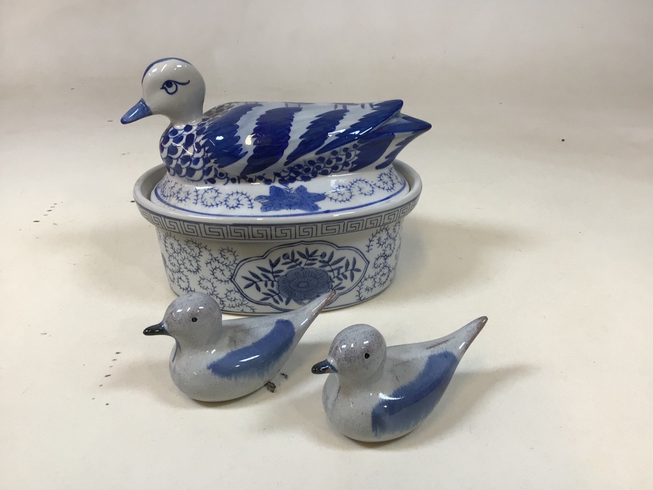 A Chinese duck dish H: 19cm together with a pair of pottery ducks