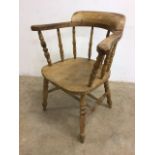 A Victorian elm seated smokers bow armchair. Seat height H:43cm