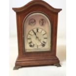 A W&H Sch German mantle clock with string inlay, silvered dial. A slow and fast chiming clock with