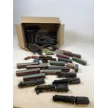 A quantity of Hornby Dublo trains and carriages in unboxed and played with condition together with a