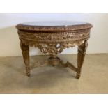 A circular marble topped table, carved gilt wood effect in a continental baroque style. W:110cm x