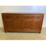 A Chinese rosewood sideboard with four drawers above cupboards with interior shelves. W:152cm x D:
