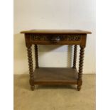 A Victorian carved oak side table with bobbin turned legs and lion mask handle to drawer above lower