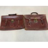 Two leather bags with brass fittings.