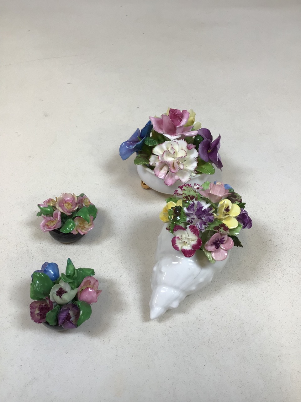 A Royal Adderley china posy shell also with two Coalport posies and one other (A/F)