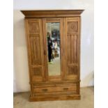 An antique pine carved single wardrobe with mirrored door drawer too base.(a.f different top)