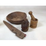 Wooden items to include a hand carved bowl, a mortar and pestle and other items