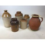 A quantity of glazed stone ware jars, an H Lawless flagon and an unglazed jug