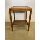 A small square oak occasional table with under shelf.