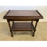 An antique oak twist and fold games table with compartment, barley twist legs and shelf. W:79cm x