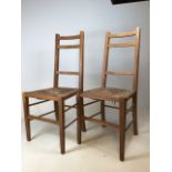 A pair of Arts and Crafts oak chairs with rush seats W:40cm x D:38cm x H:93cm