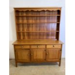 A late mid century teak dresser by Reynolds of Ludlow with stamp inside drawer. W:157cm x D:48cm x