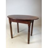 A small oval,country style side table with turned legs W:62cm x D:42cm x H:47cm