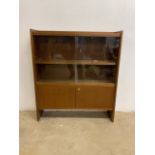 A USSR made mid century bookcase with glazed sliding doors to slightly adjustable shelf with