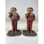 A Pair of early 1900s continental tin plate dog figure candlestick holders, one with matchbox holder