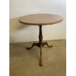 An oak circular tilt top table with tripod base. W:75cm x D:75cm x H:80cm