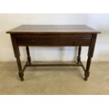 An oak desk table with large central drawer with brass handles. W:96cm x D:50cm x H:67cm