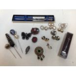 A sterling silver letter opener, a silver thistle brooch, hat pins, costume jewellery brooches and