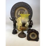 Brass chargers, an oil lamp, a pair of spelter figures and a Smiths Bakelite clock