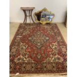 A red blue and cream Persian style rug also with a small Demi lune inlaid table and a ornate gilt