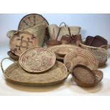 A quantity of various African and modern wicker, rush and palm woven baskets, bowls and other items.