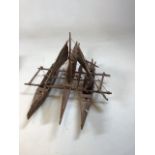 A Solomon Islands wood model Proa or canoe of 3 hulls. With 2 sails, paddles and model fish.