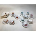 A Swedish set of 10 porcelain fluted cups and saucers, decorated with different coloured