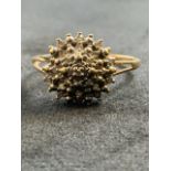 A 9ct gold and diamond cluster ring, size p. Marked 375 dia 0.10.