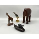 An East African polished hardwood bull elephant, an ebony duck, a hardwood giraffe and a horn bird