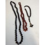 A jet black faceted bead necklace, with a Carnelian bead necklace and an Egyptian bracelet with