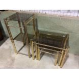 A vintage gilt metal and smoked glass nest of tables also with a two tier table. Two tier table. W: