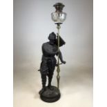 A large figural spelter oil lamp of an armoured soldier supporting lamp W:36cm x H:103cm